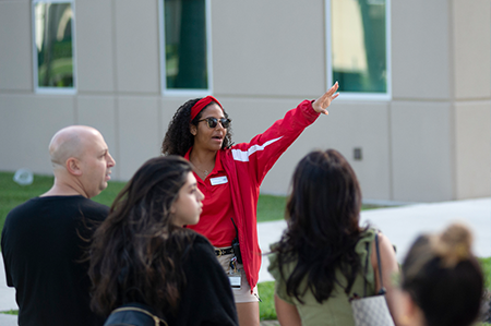 Female guide pointing and explaining to visitors